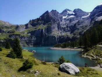 Scenic view of lake and mountains against sky