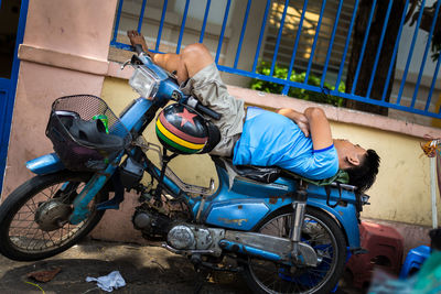 Side view of people riding bicycle on road