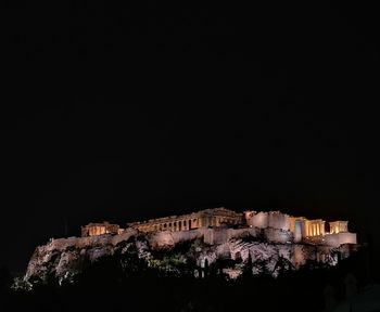 Low angle view of illuminated building against sky at night