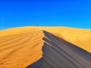 Walking in hill of sand dunes
