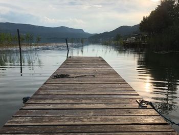 Pier over lake against sky