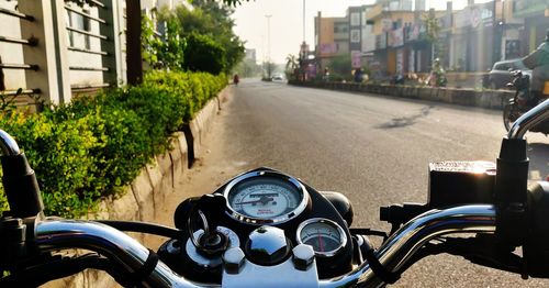 Close-up of motorcycle on road in city