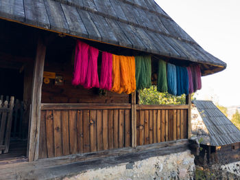 Clothes drying on clothesline by building against sky