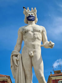 Low angle view of statue against blue sky