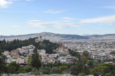 Buildings in town against sky