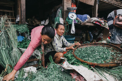 People working at market stall