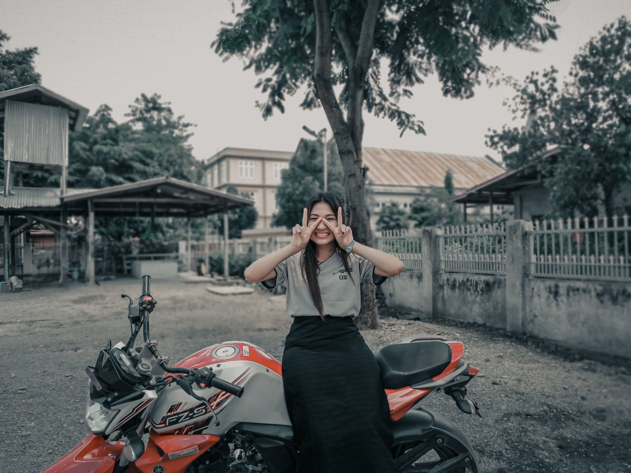 transportation, lifestyles, architecture, real people, one person, mode of transportation, building exterior, leisure activity, young adult, built structure, motorcycle, front view, casual clothing, land vehicle, young women, adult, portrait, day, focus on foreground, riding, outdoors, beautiful woman