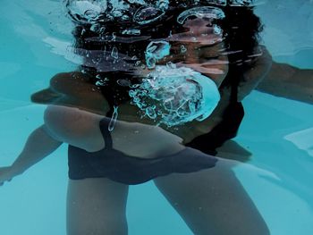 Teenage girl swimming in pool