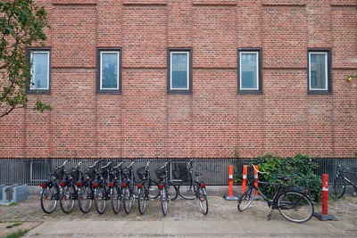 Bicycle parked against brick wall