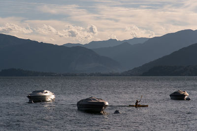 Sailboats in lake against sky