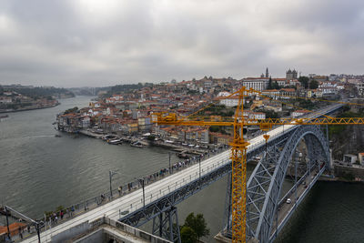 High angle view of bridge over river in city against sky