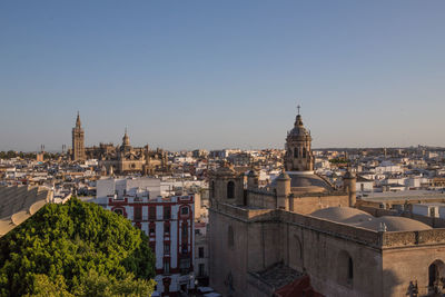 Panoramic view of buildings in city against clear sky