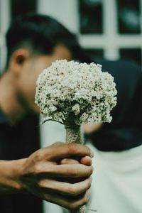 Close-up of hand holding flower bouquet