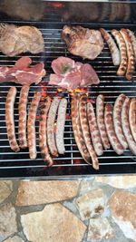 High angle view of meat on barbecue grill