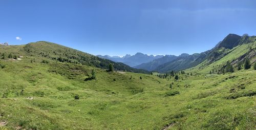 Scenic view of mountains against blue sky