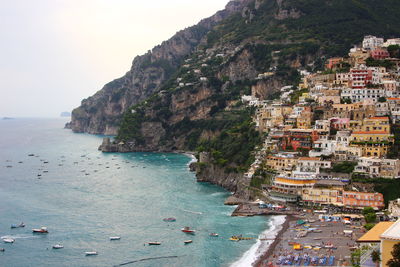 Aerial view of sea and buildings against sky