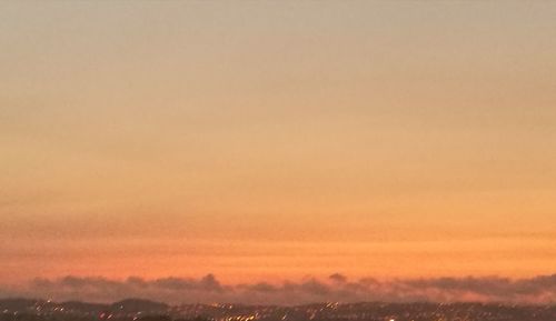 Scenic view of landscape against sky at sunset