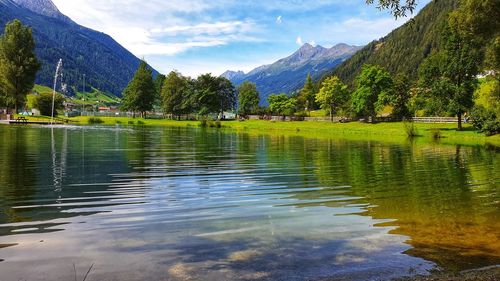 Scenic view of lake and mountains against sky