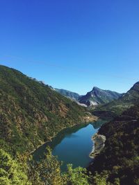 Scenic view of mountains against clear blue sky