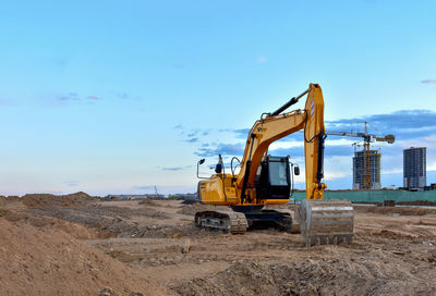 Excavator during road work at construction site. screeding the gravel 