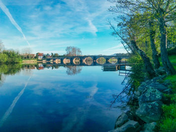 Arch bridge over river against sky