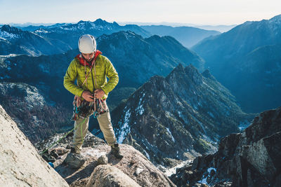 Man standing on rocks against mountains