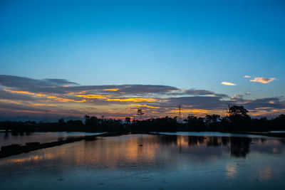 Scenic view of lake against sky during sunset