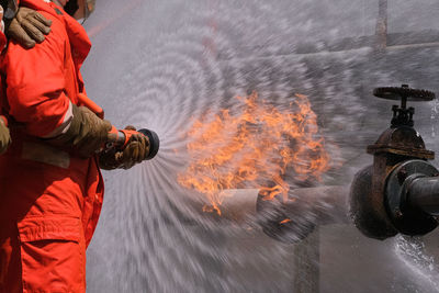 Rear view of man standing in puddle