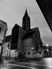 Low angle view of illuminated building against sky at night