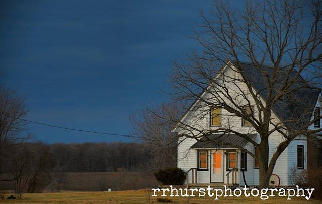 bare tree, architecture, building exterior, built structure, tree, branch, sky, low angle view, house, outdoors, blue, no people, text, clear sky, day, residential structure, nature, western script, communication, building