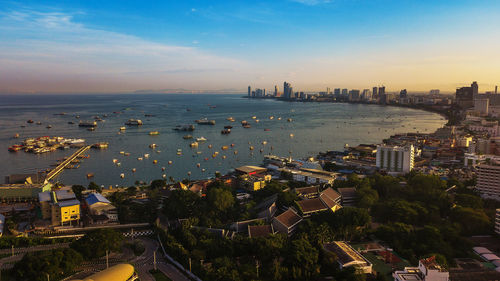 High angle view of buildings by sea against sky