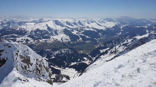 Scenic view of snow covered mountains against sky