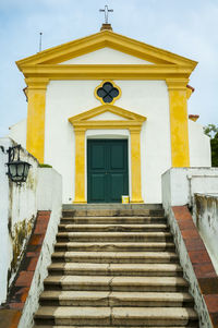 Low angle view of yellow building against sky