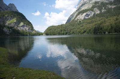 Scenic view of lake by trees against sky