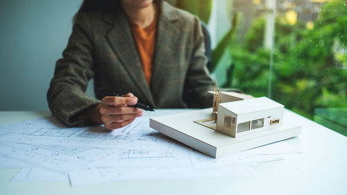 Midsection of businessman working on table