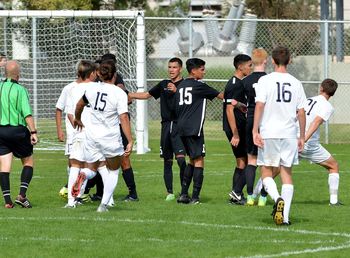 Group of people standing on soccer field