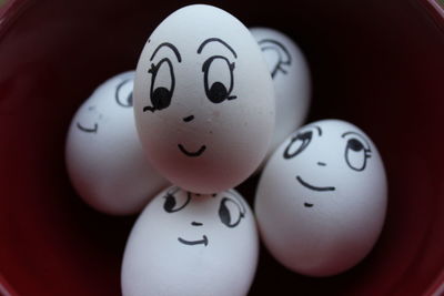 Close-up of face drawn on easter eggs in bowl