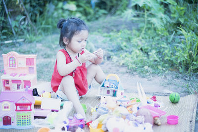 Portrait of cute girl sitting on field