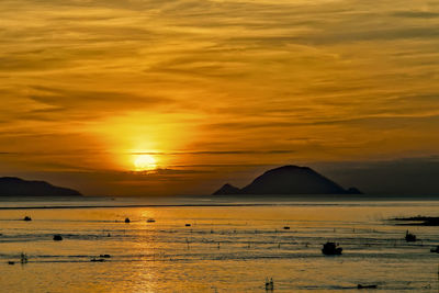 Scenic view of sea against orange sky