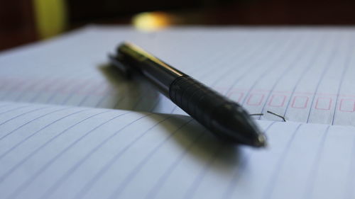 High angle view of pen on book