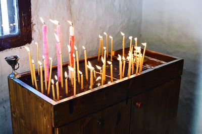 Lit candles on altar in church