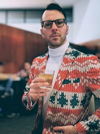 Portrait of fashionable man drinking whiskey