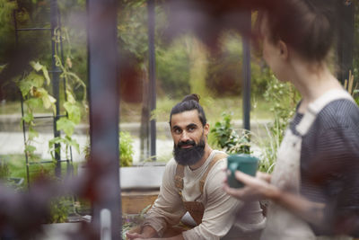 Friends talking in greenhouse