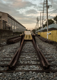 View of railroad tracks against cloudy sky