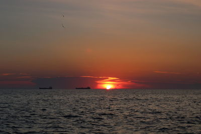 Scenic view of sea against orange sky