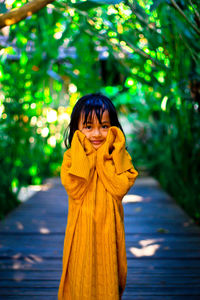 Portrait of a smiling young woman standing outdoors