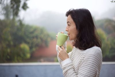 Woman holding coffee cup