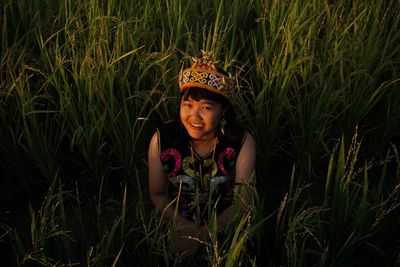 Portrait of a smiling young woman on field