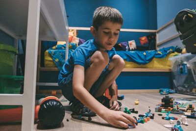 Boy playing with toy car at home