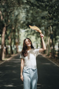 Portrait of a smiling young woman standing outdoors